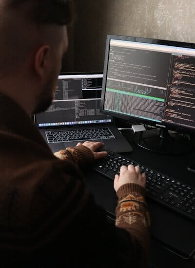 a man sitting in front of a computer on a desk